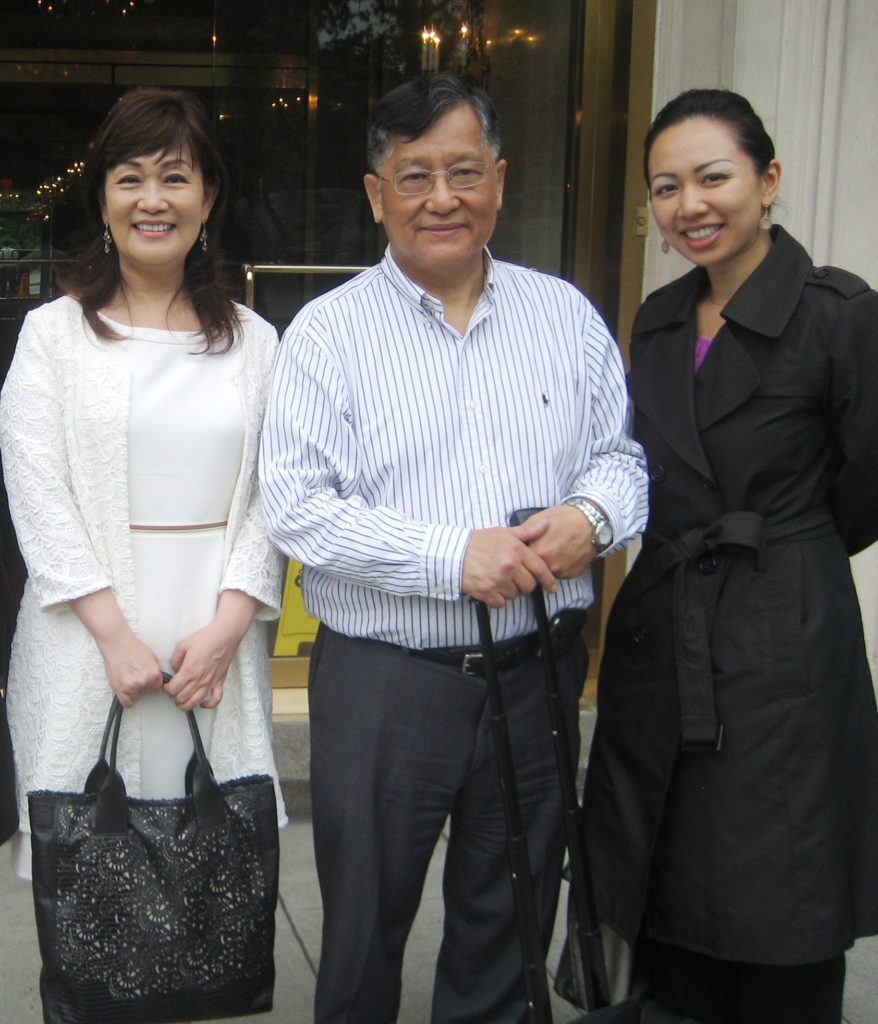 Chinese Speaking Agent Eileen Hsu and Mr. and Mrs. Liu by the condo they purchase.